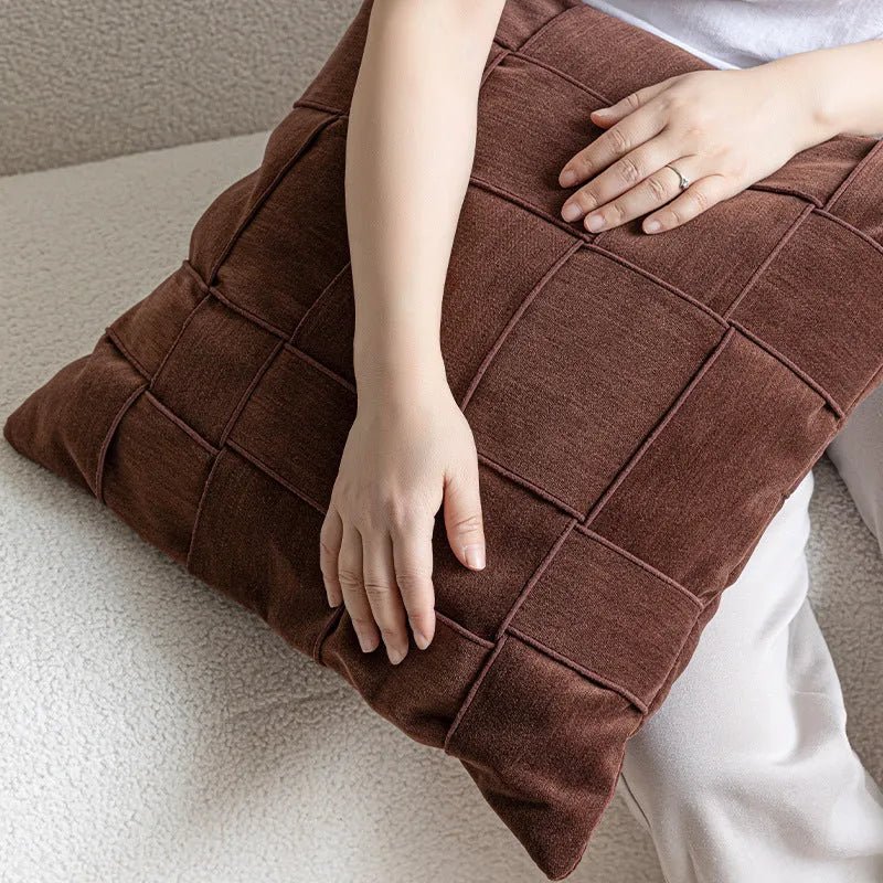Square woven chenille pillow cushion in beige colour on a grey sofa, 50cm by 50cm size.
