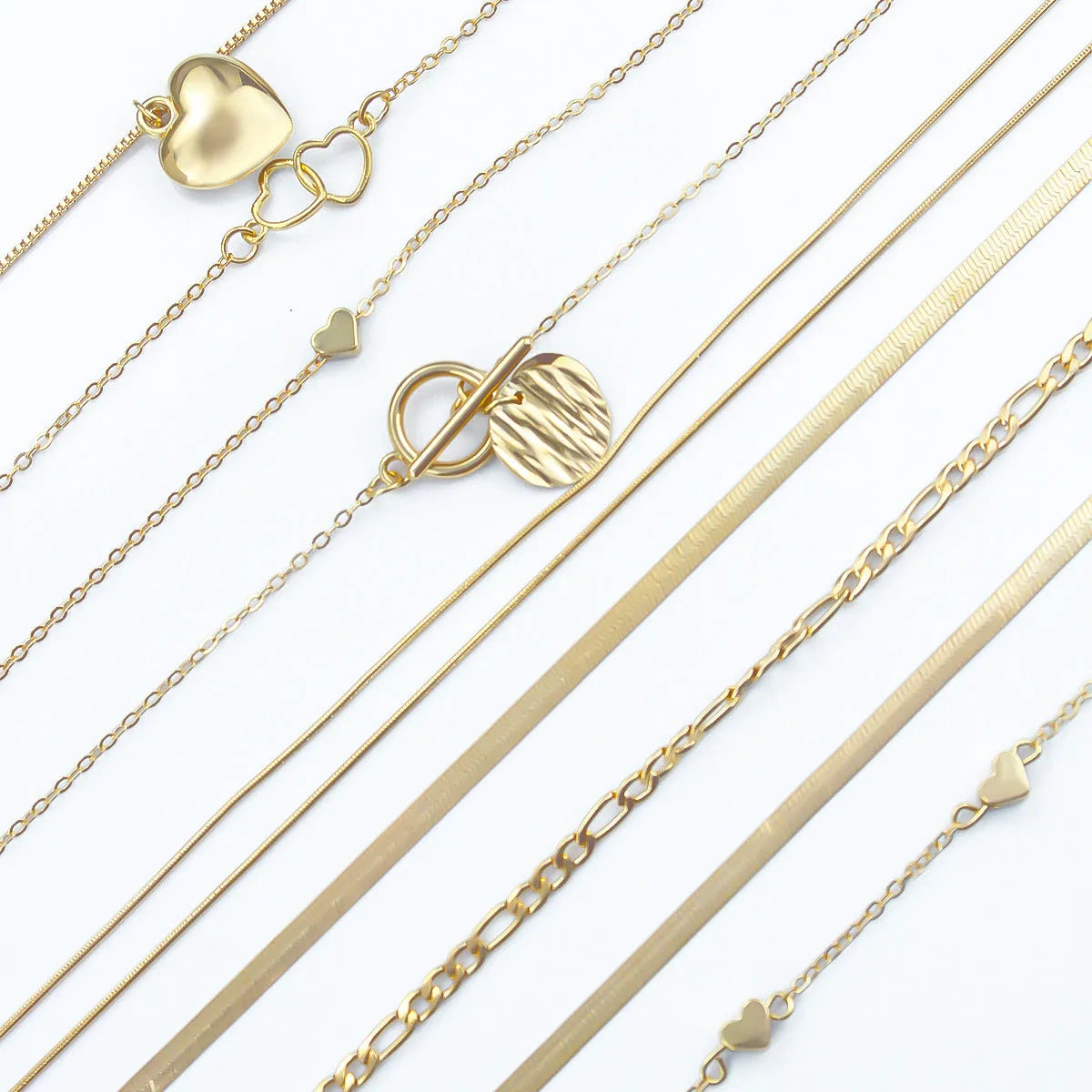 Set of 10 gold women's necklaces with adjustable chains and alloy pendants displayed in gift packaging