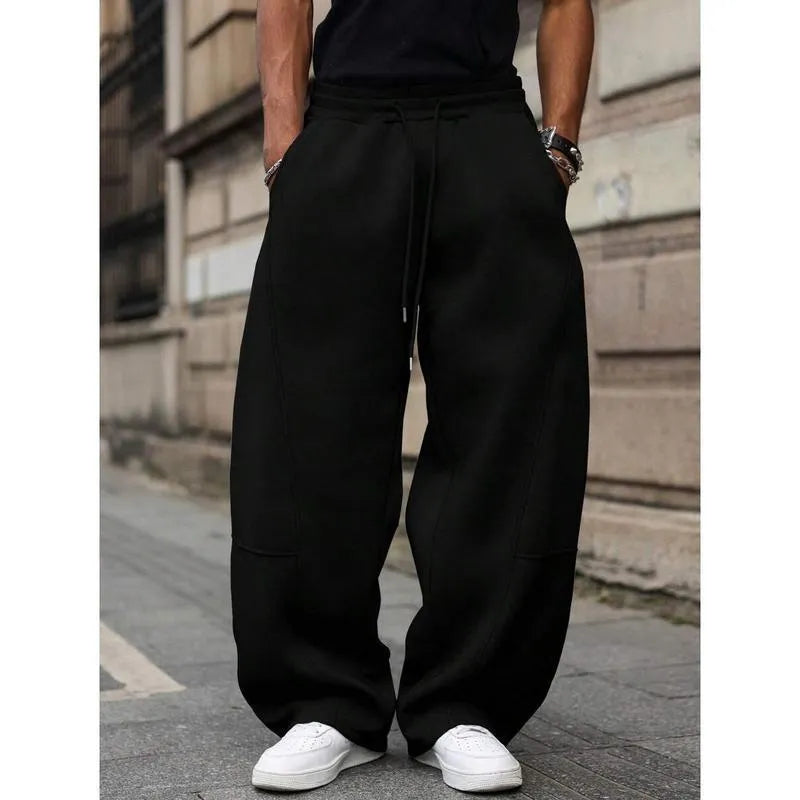 Men's high-waisted straight-leg casual trousers in a neutral colour, showing the cropped length and elasticated fit.