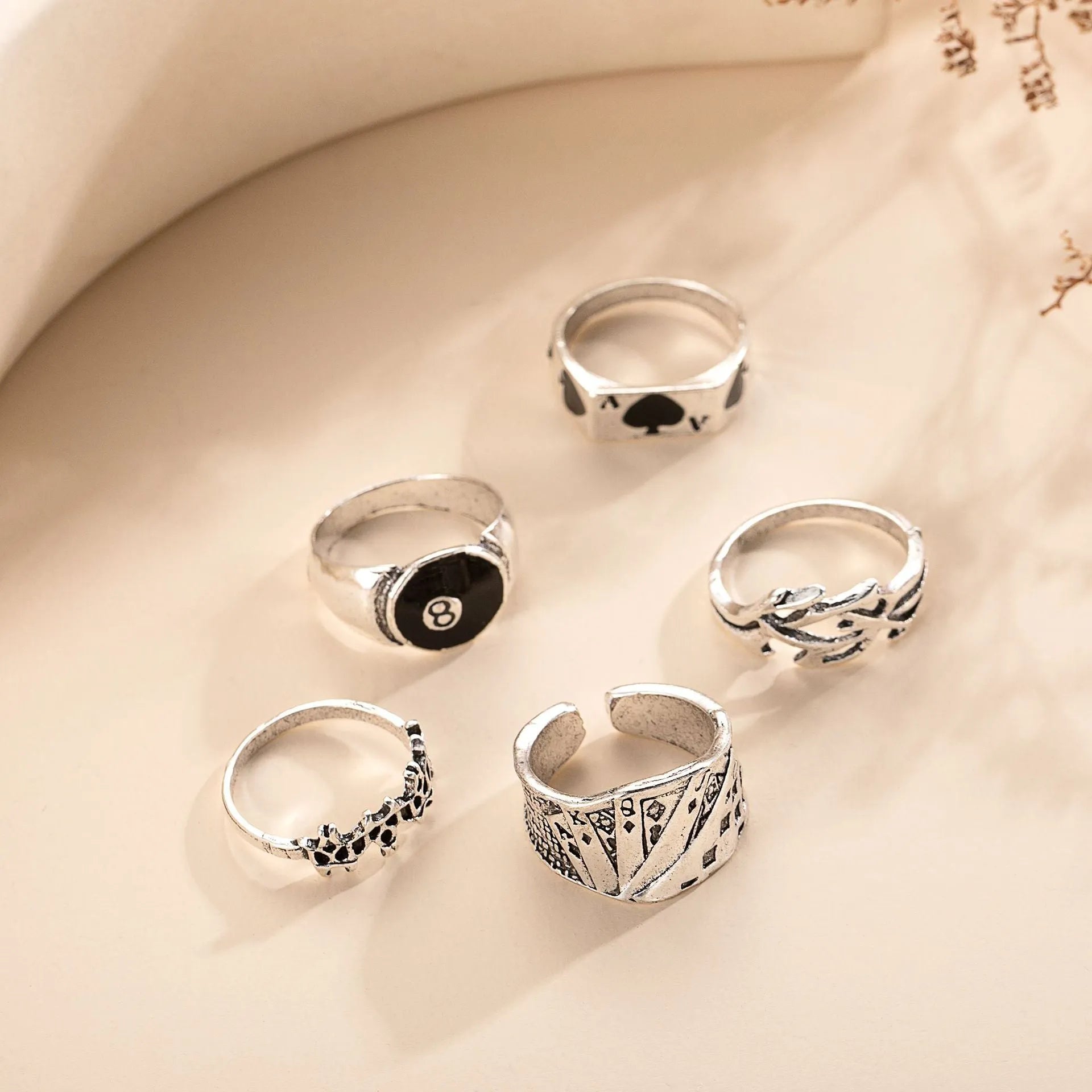 Black alloy fashion ring with a raised retro poker card spade design on a finger.