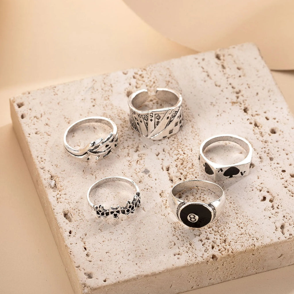 Black alloy fashion ring with a raised retro poker card spade design on a finger.
