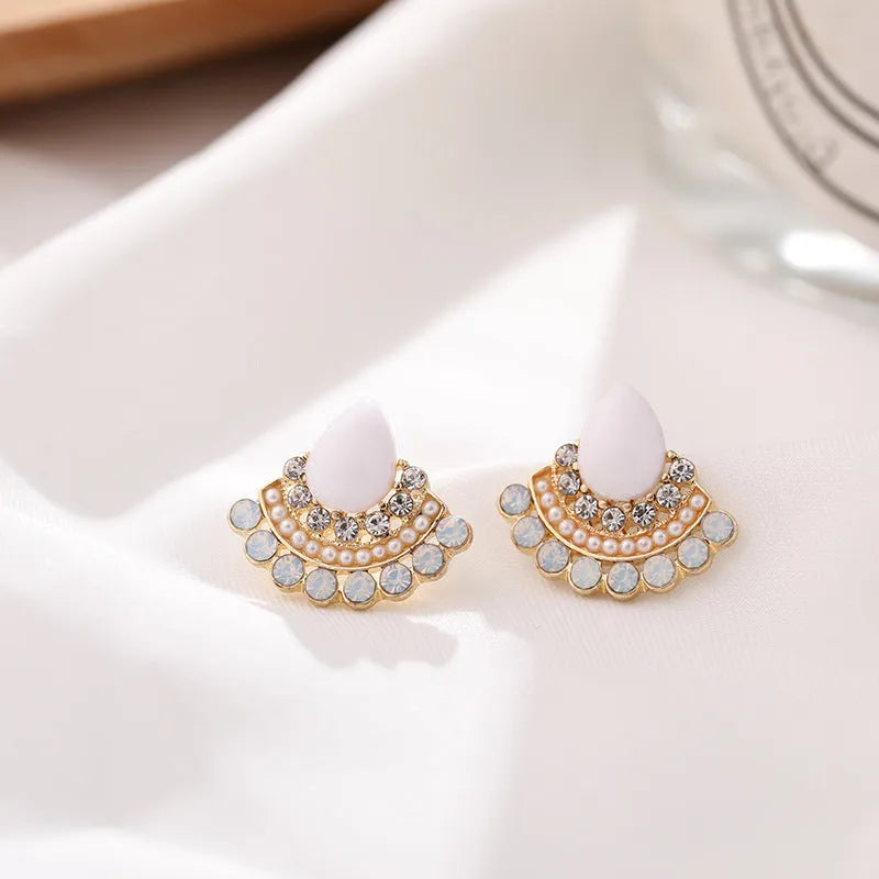 Women's silver-colour retro fan-shaped stud earrings with rhinestone detail on a white background.