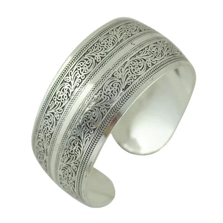 Silver Miao ethnic carved openwork Roman bracelet with elephant motif on alloy material