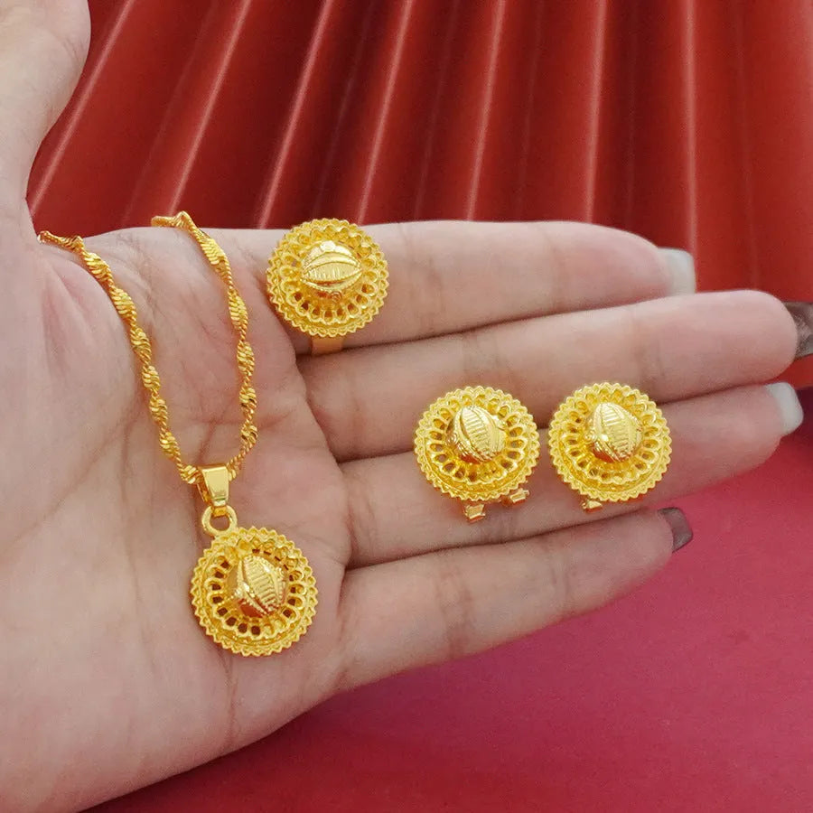 Gold-coloured three-piece jewellery set showing necklace with water wave chain, floral design earrings, and matching ring.