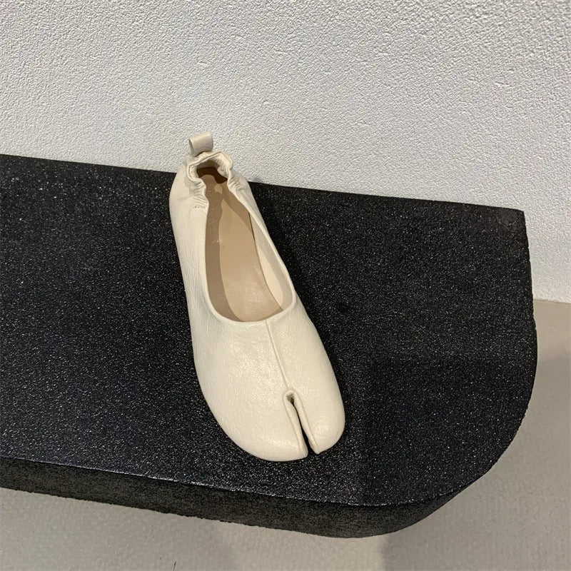 Women's apricot coloured chunky low heel pumps with round toe and split toe horseshoe design detail.