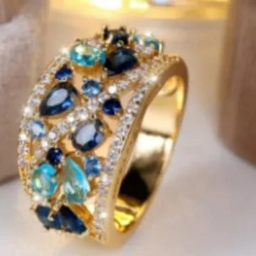 Women's hollow round copper fashion ring showing gold and platinum finishes with sapphire blue and white diamond accent options