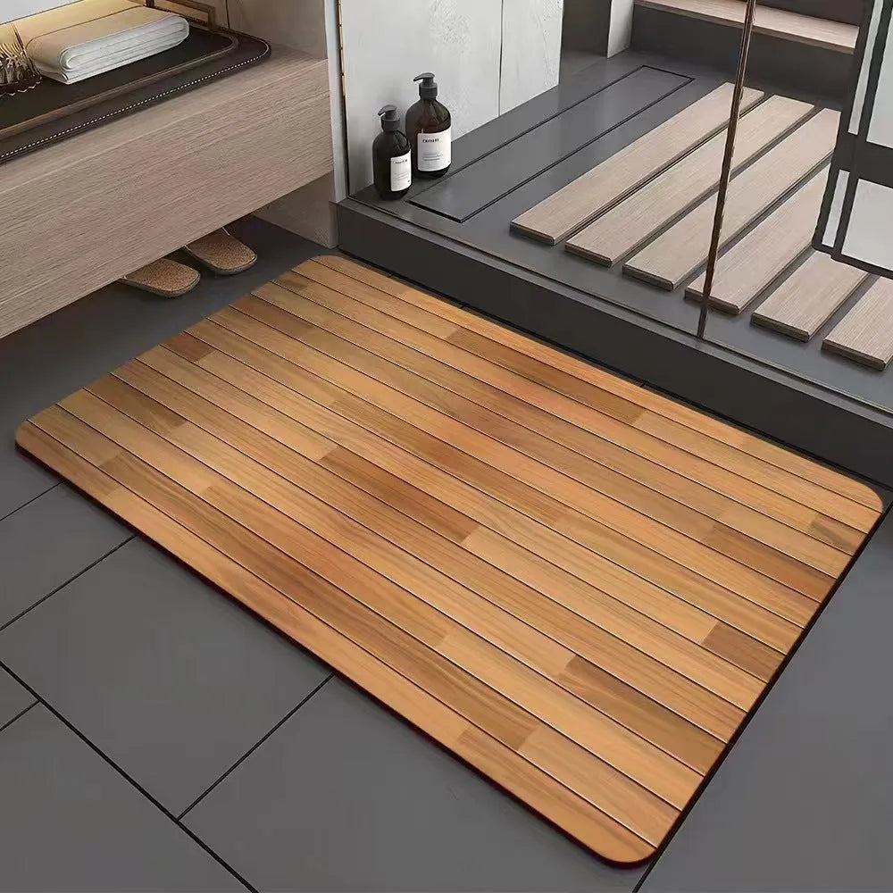 Square diatomite bathroom mat with wood grain pattern on a bathroom floor.