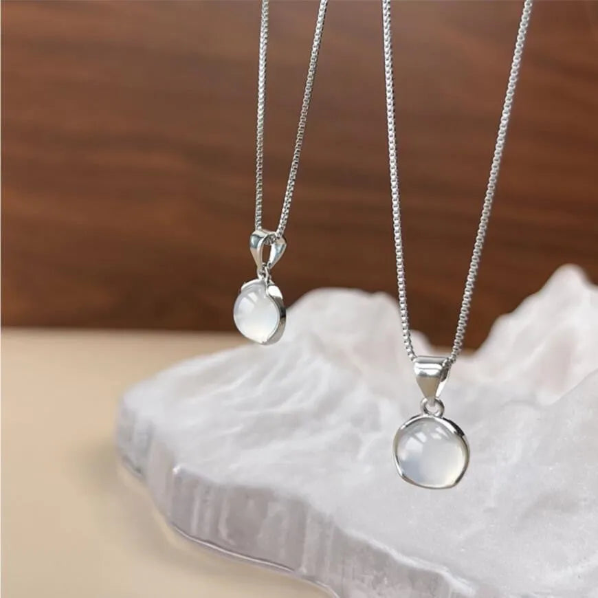 Korean-style oval pendant necklace with an eight-point star on an adjustable silver-toned box chain.