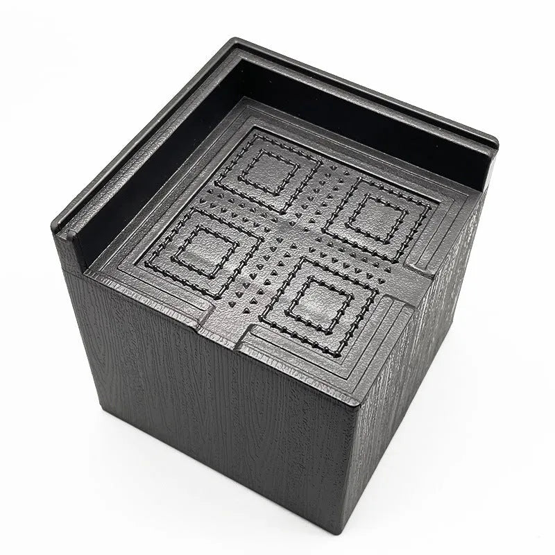 Four black plastic furniture foot mats for raising bed or sofa legs on hard floors.