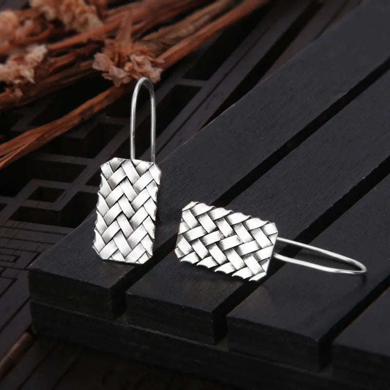 Geometric diamond plaid pattern earrings made from silver-coloured 925 silver.