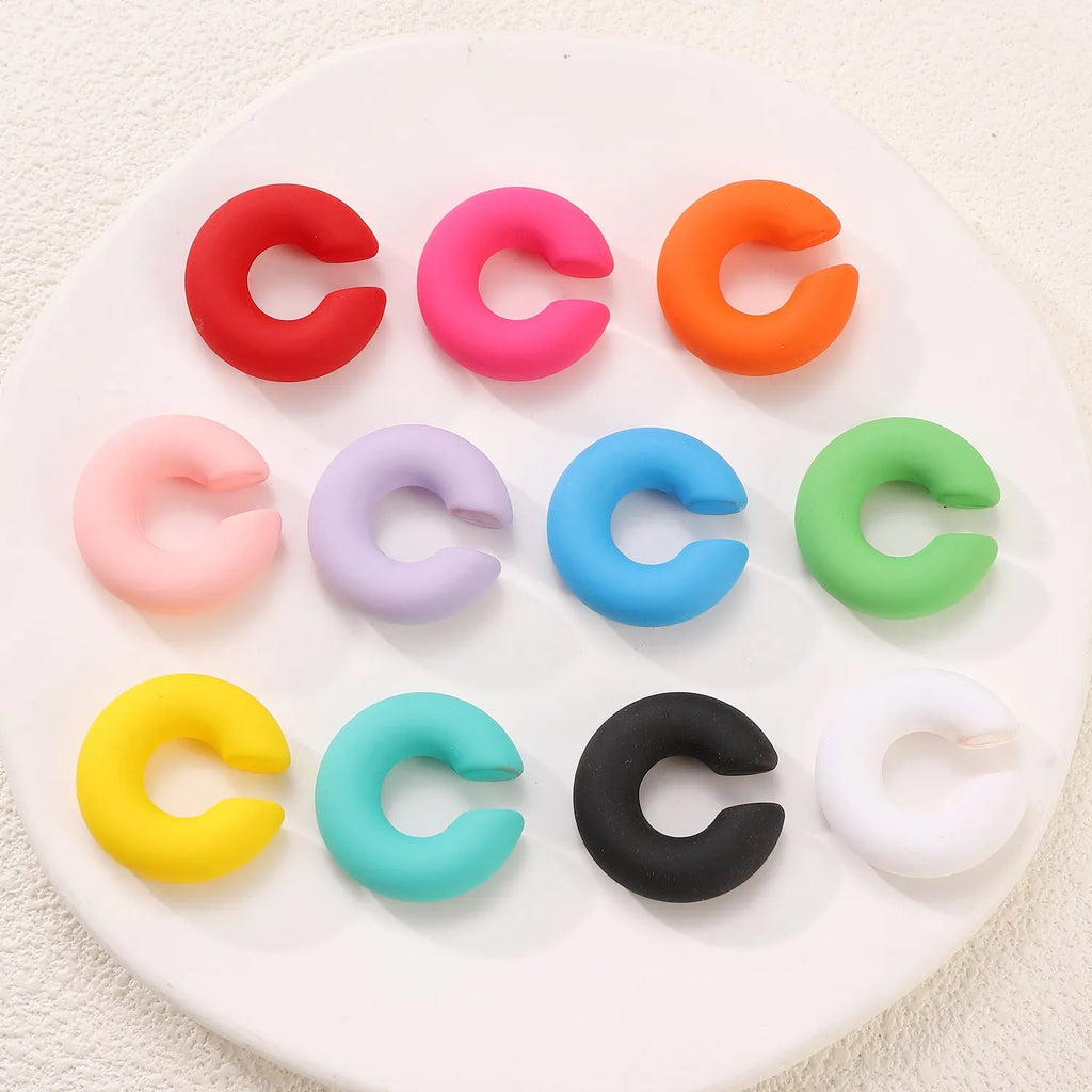 C-shaped geometric clip-on earrings in matte coarse texture with 15 candy colour options including yellow, cyan, purple and pink