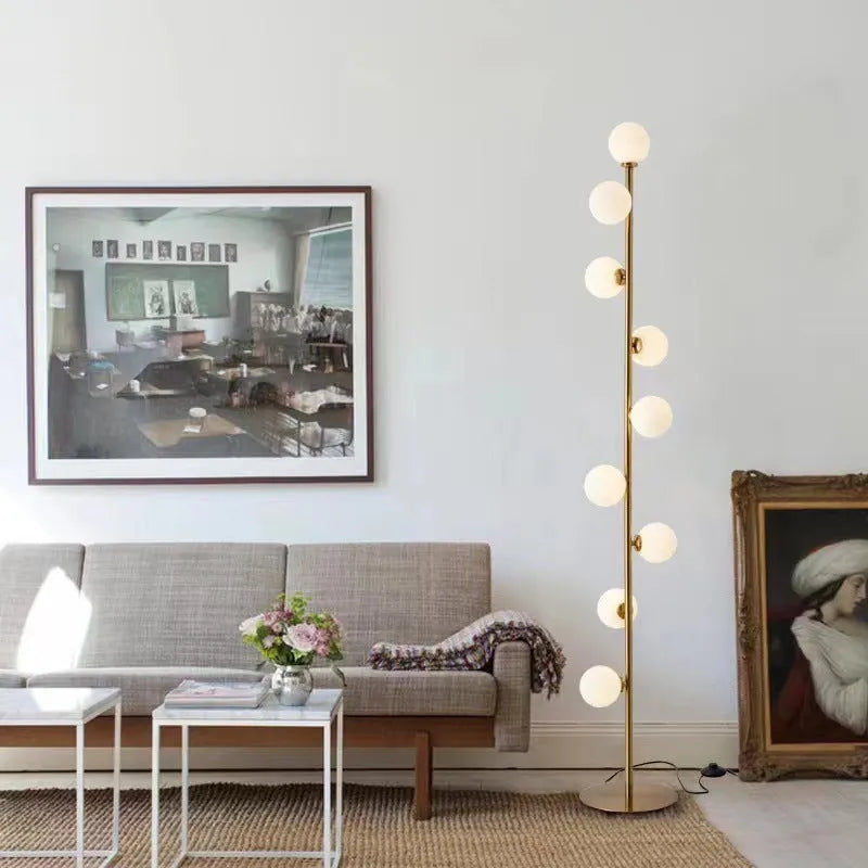 Minimalist modern floor lamp with wrought iron and glass construction, marble base, and adjustable light colours.