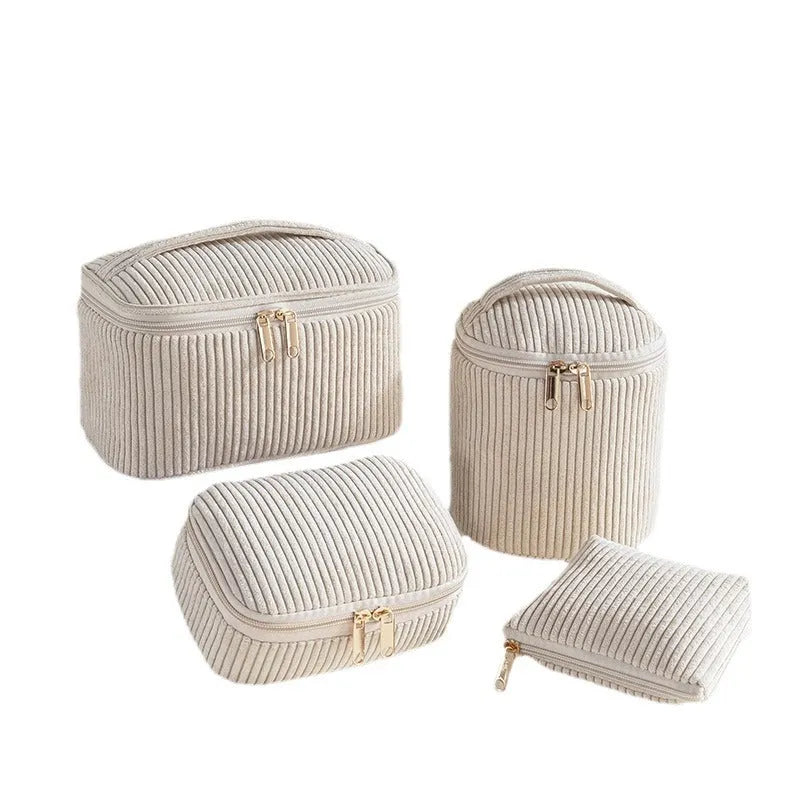 Four cube-shaped polyester makeup bags in matching colour set for travel organisation