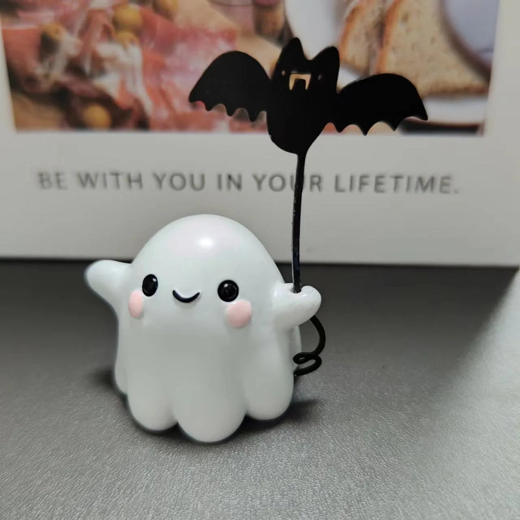 Small hand-painted resin statue of a ghost walking a dog and holding a bat, a miniature Halloween ornament.