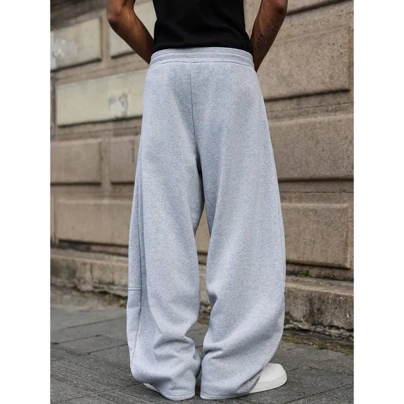 Men's high-waisted straight-leg casual trousers in a neutral colour, showing the cropped length and elasticated fit.