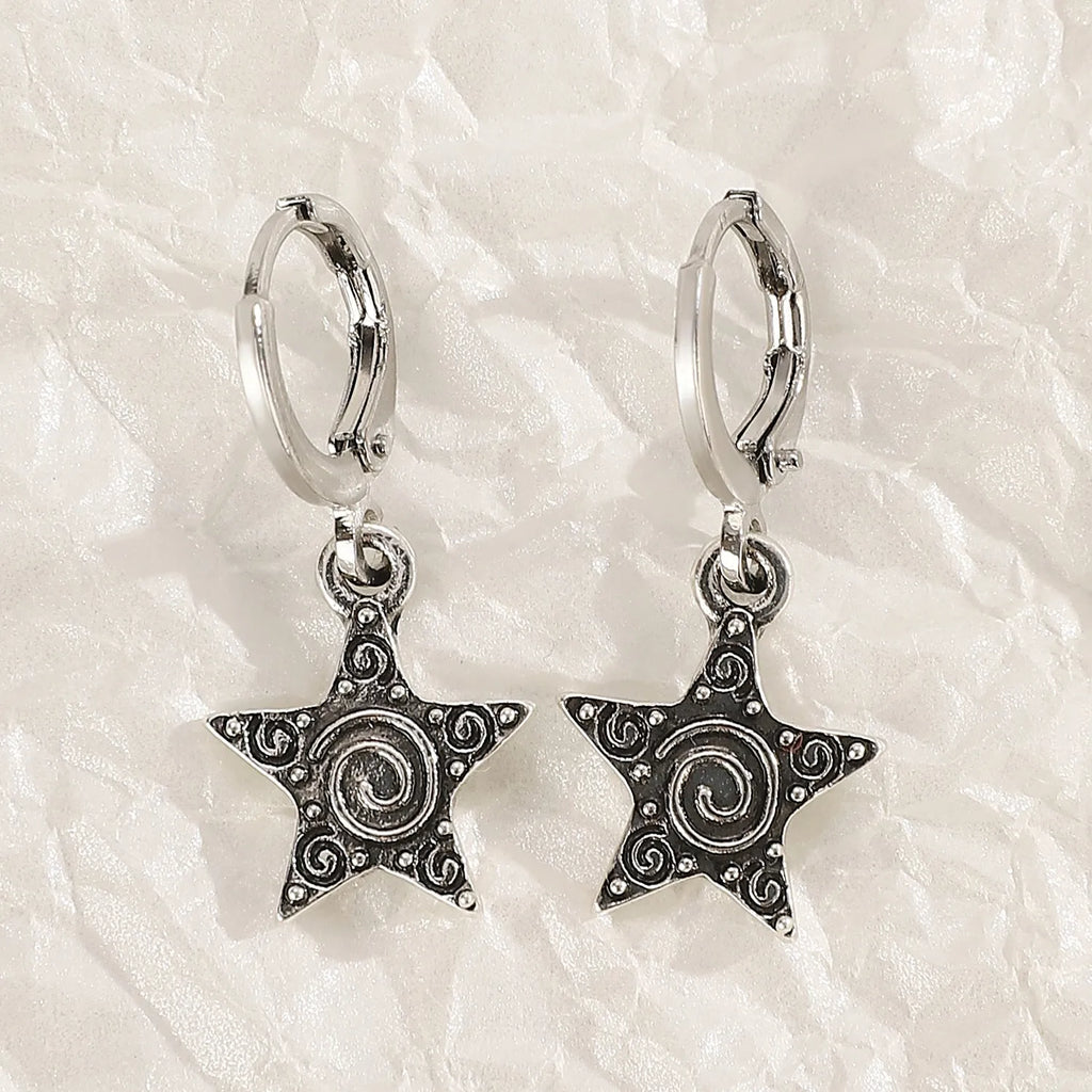 Women's classic alloy earrings showing cross, heart, and animal designs in white, black, and silver colours