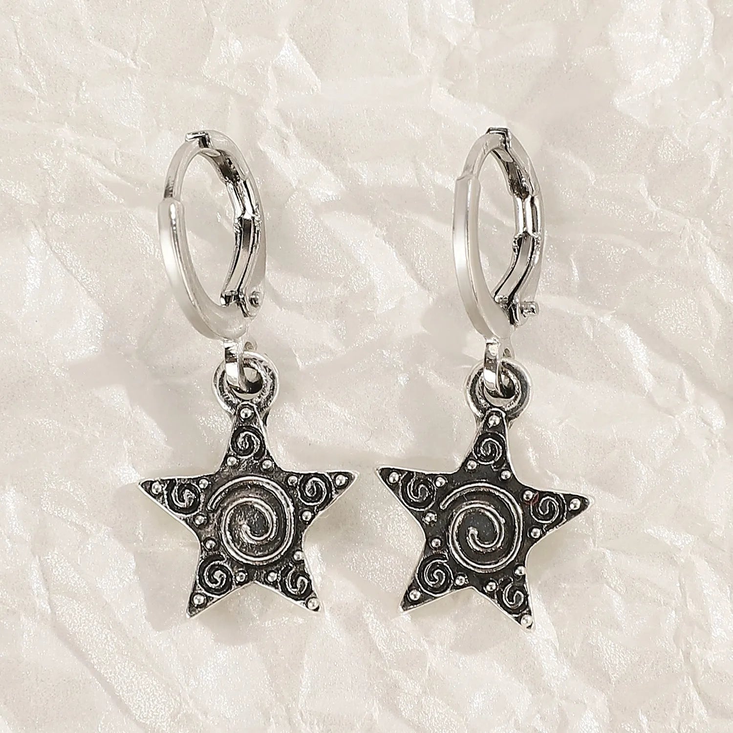 Women's classic alloy earrings showing cross, heart, and animal designs in white, black, and silver colours