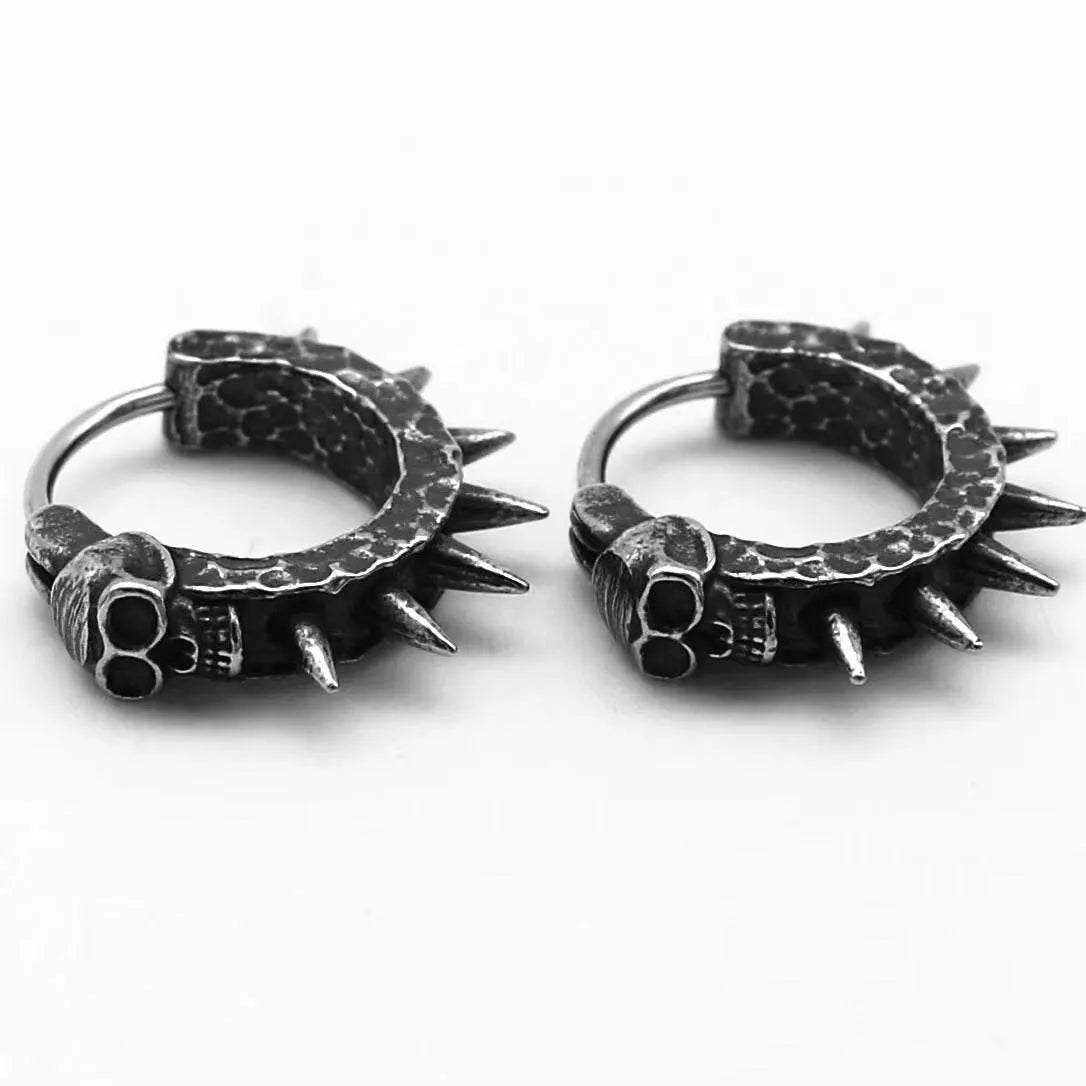 A pair of copper-coloured geometric punk motorcycle earrings with a black retro design on a hook fastening.