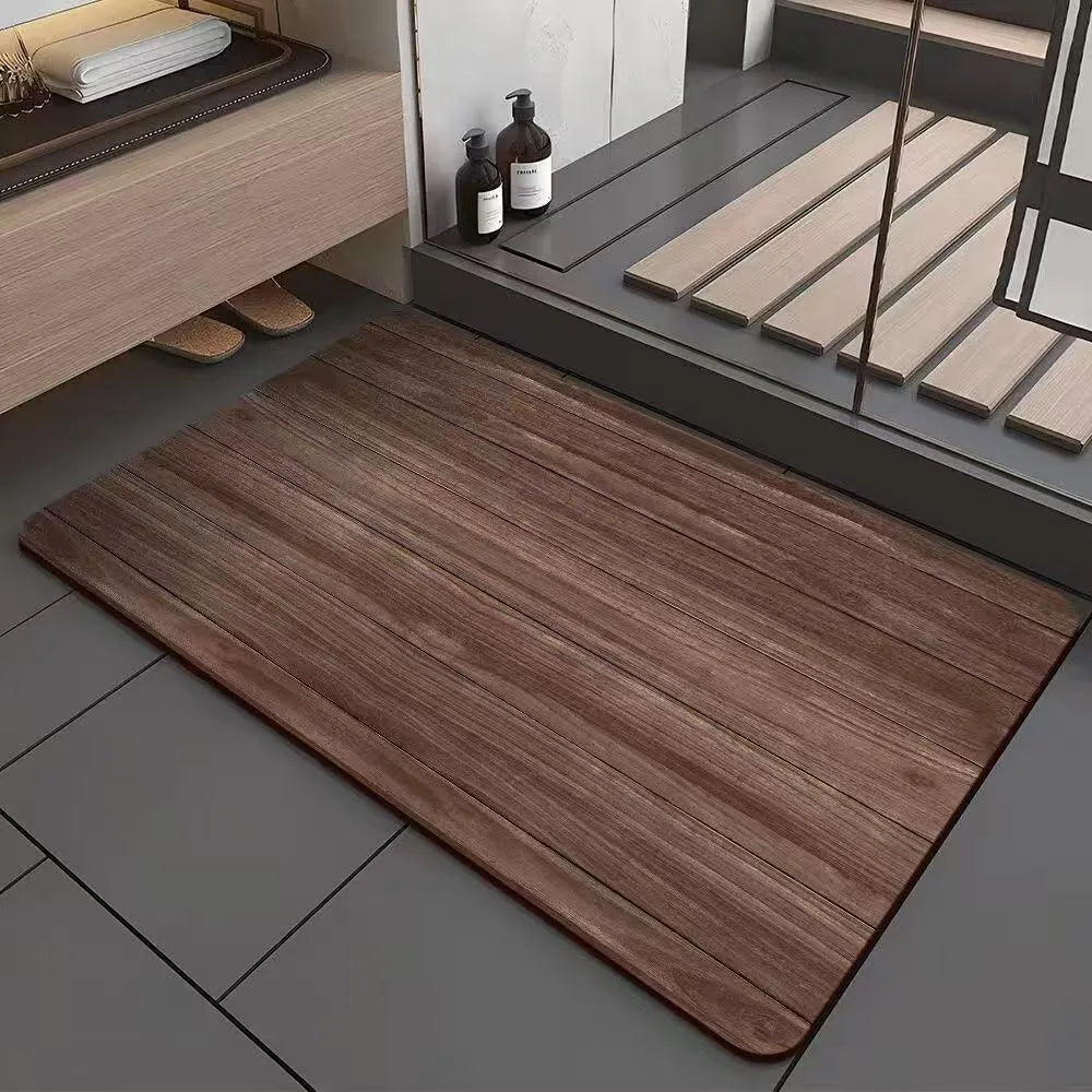Square diatomite bathroom mat with wood grain pattern on a bathroom floor.