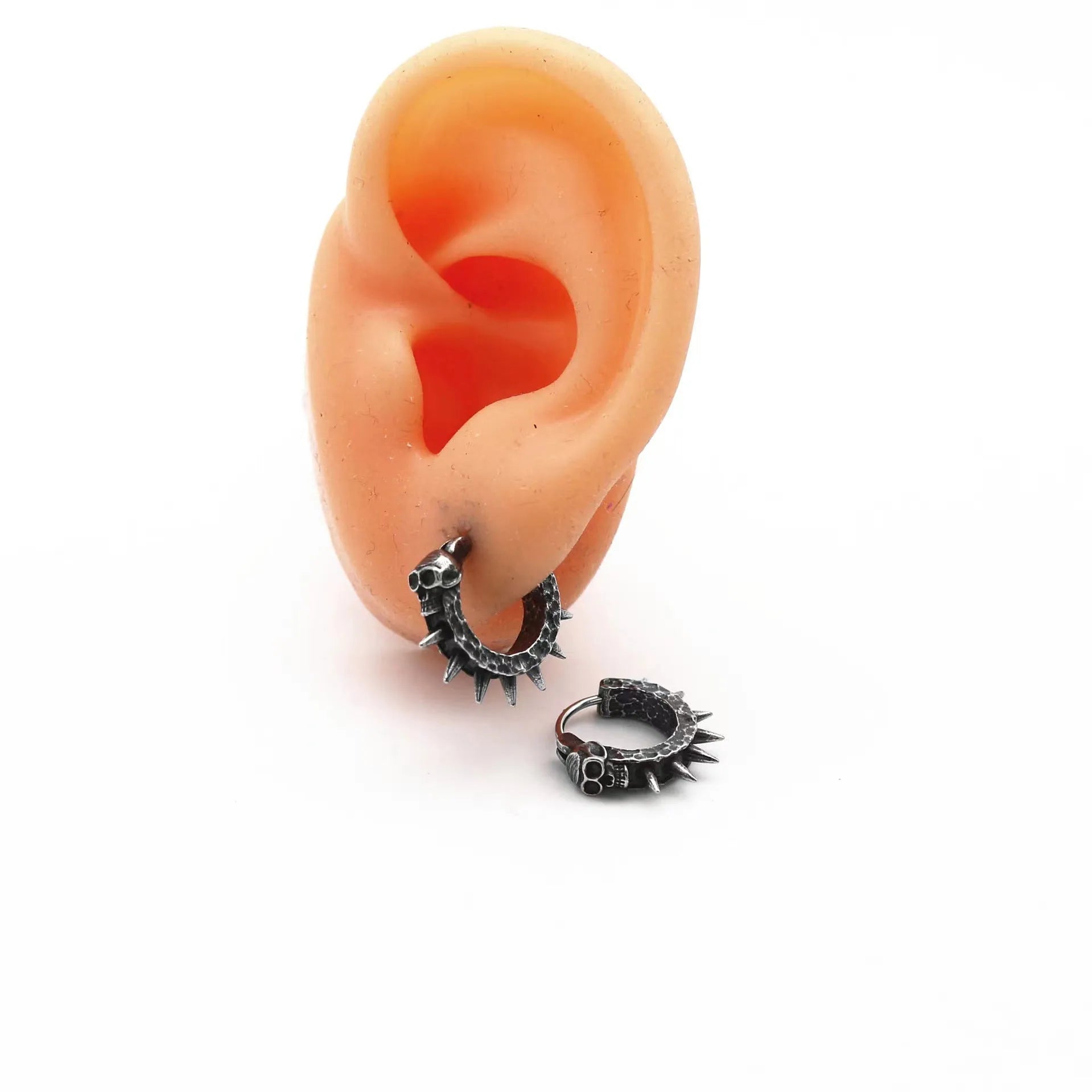A pair of copper-coloured geometric punk motorcycle earrings with a black retro design on a hook fastening.