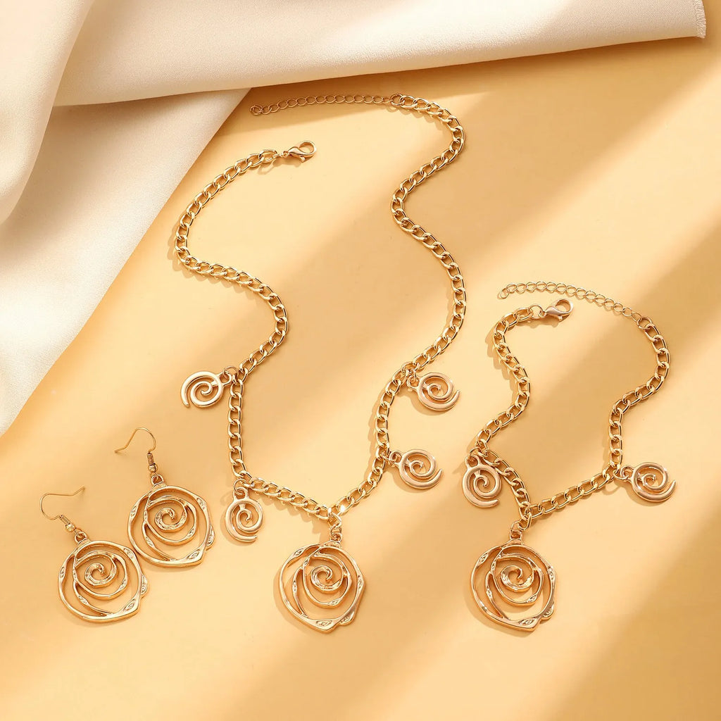 Spiral donut jewellery set showing necklace, bracelet and ear hooks in gold or silver geometric circle design