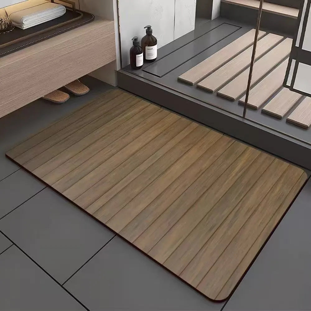 Square diatomite bathroom mat with wood grain pattern on a bathroom floor.