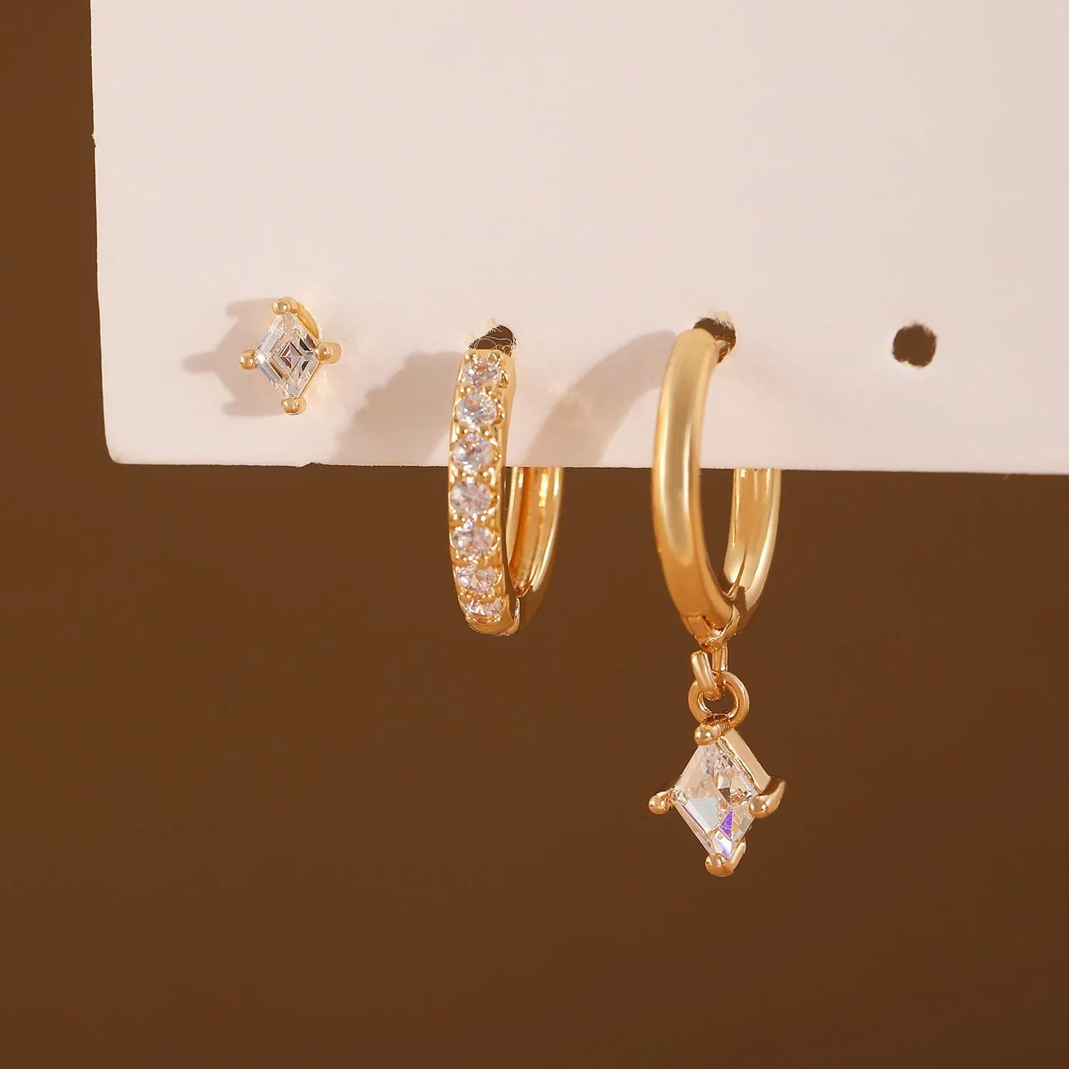 Ladies three-piece zircon inlaid geometric earring set with pendant, stud and clip styles in gold finish