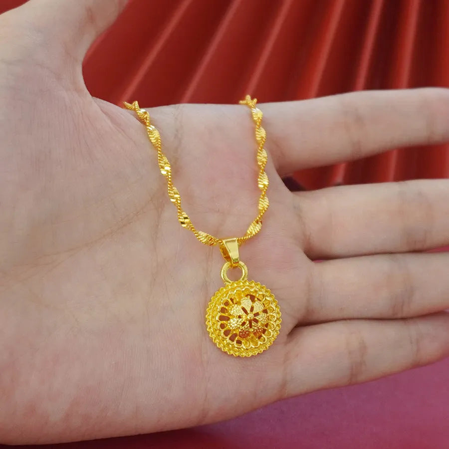 Gold-coloured three-piece jewellery set showing necklace with water wave chain, floral design earrings, and matching ring.