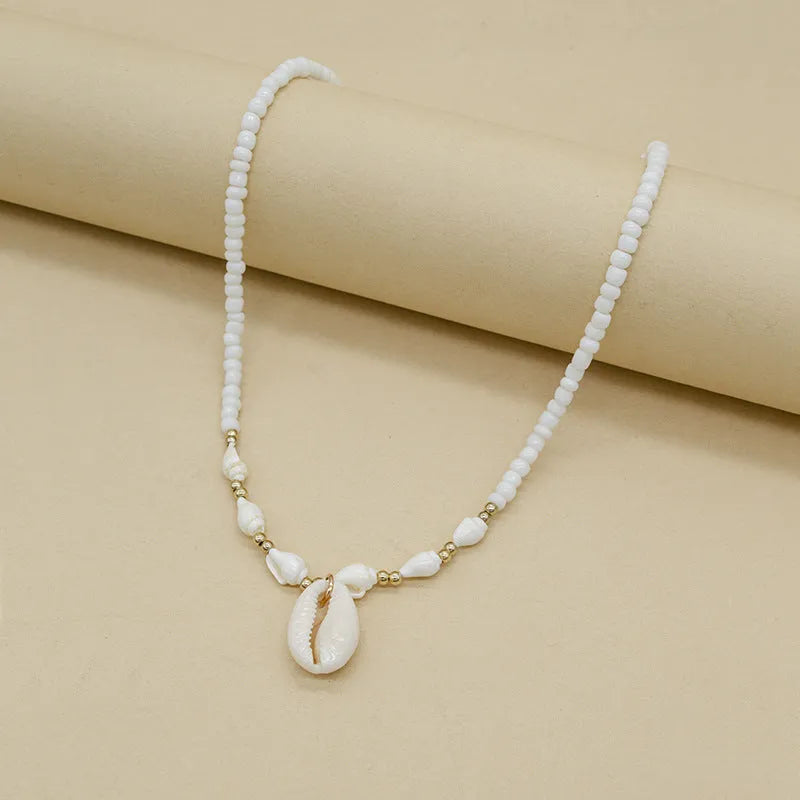 White conch shell necklace for women with a mother of pearl pendant on a regular chain.