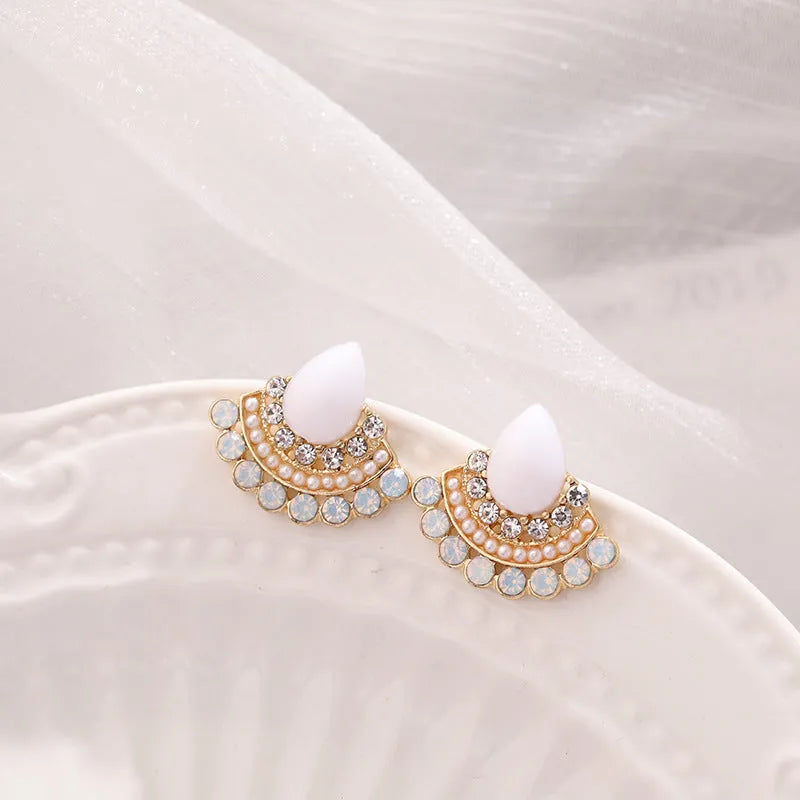 Women's silver-colour retro fan-shaped stud earrings with rhinestone detail on a white background.