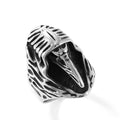 Geometric crow punk ring in titanium steel, MR166 colour, shown on a finger.