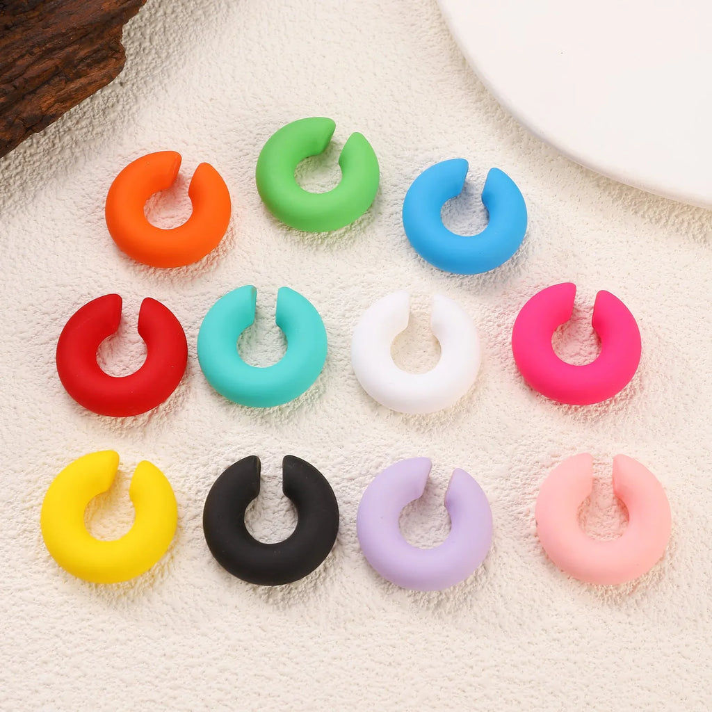 C-shaped geometric clip-on earrings in matte coarse texture with 15 candy colour options including yellow, cyan, purple and pink