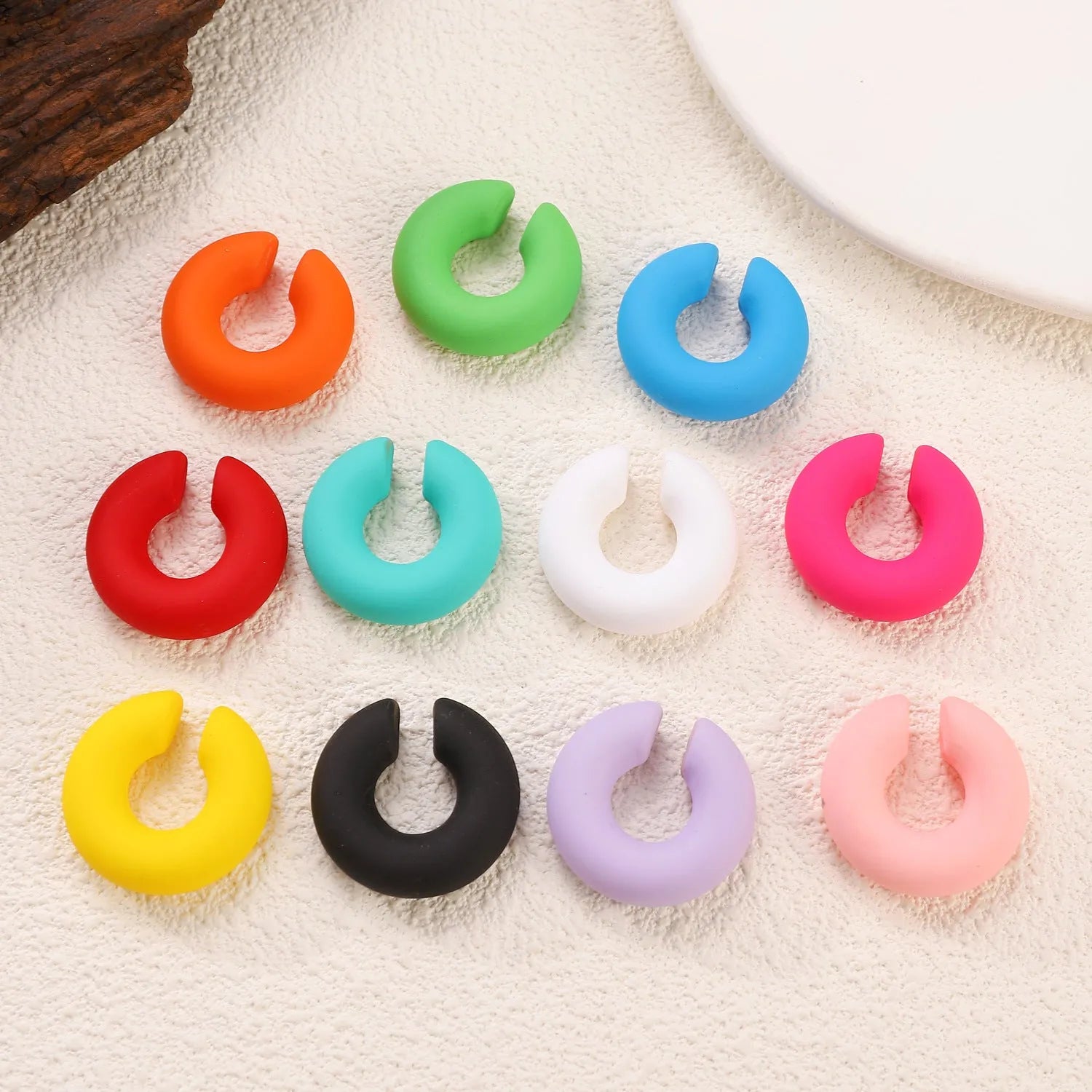 C-shaped geometric clip-on earrings in matte coarse texture with 15 candy colour options including yellow, cyan, purple and pink