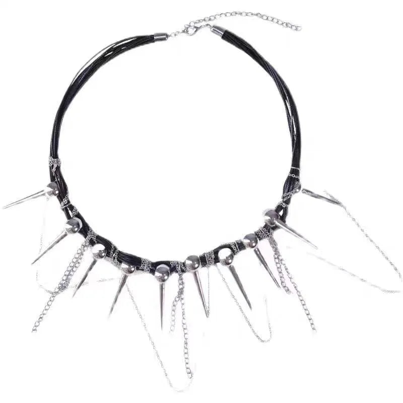 Leather necklace with round beads, a tassel, and silver rivet details on a white background.