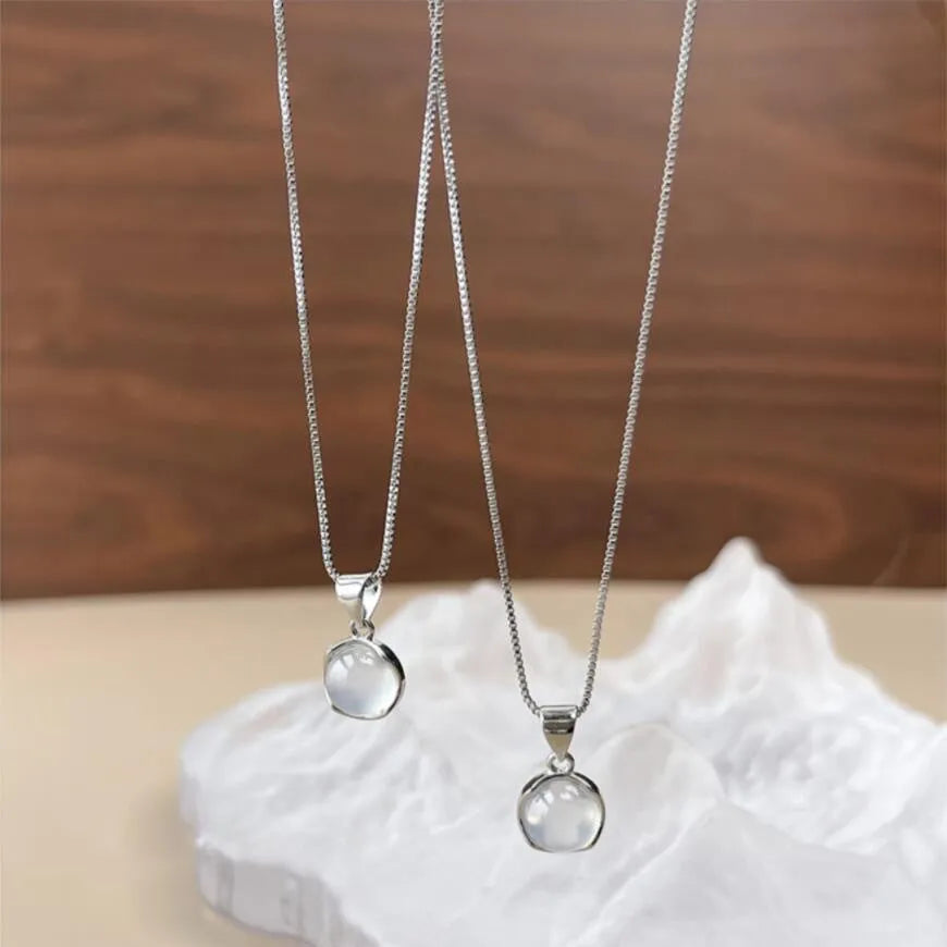 Korean-style oval pendant necklace with an eight-point star on an adjustable silver-toned box chain.