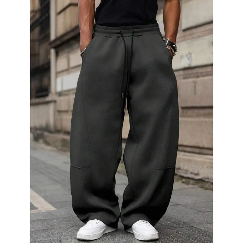 Men's high-waisted straight-leg casual trousers in a neutral colour, showing the cropped length and elasticated fit.