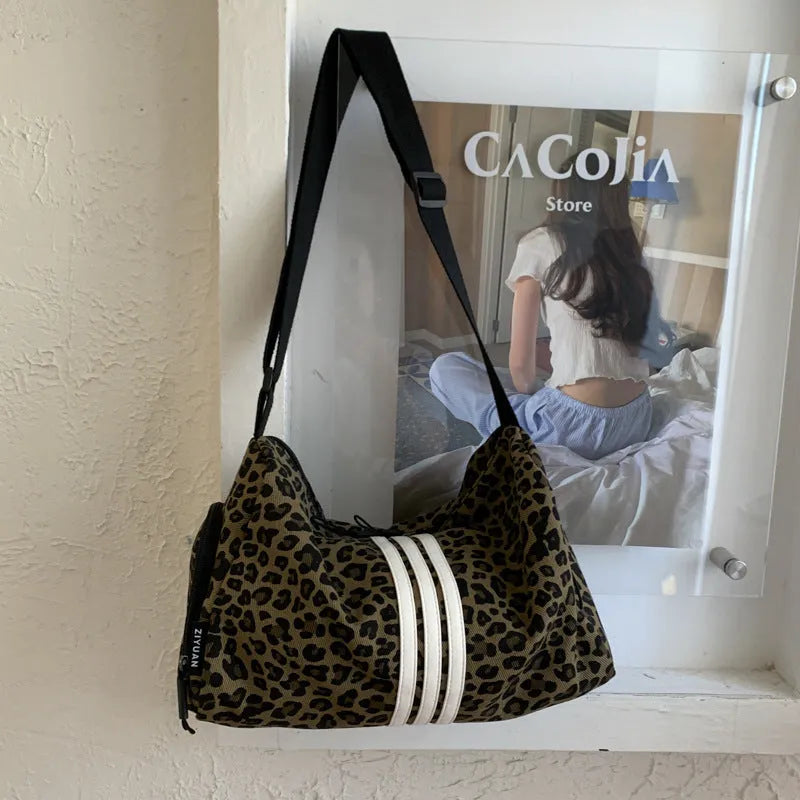 Leopard print sports style shoulder messenger bag with striped lining and stitching details