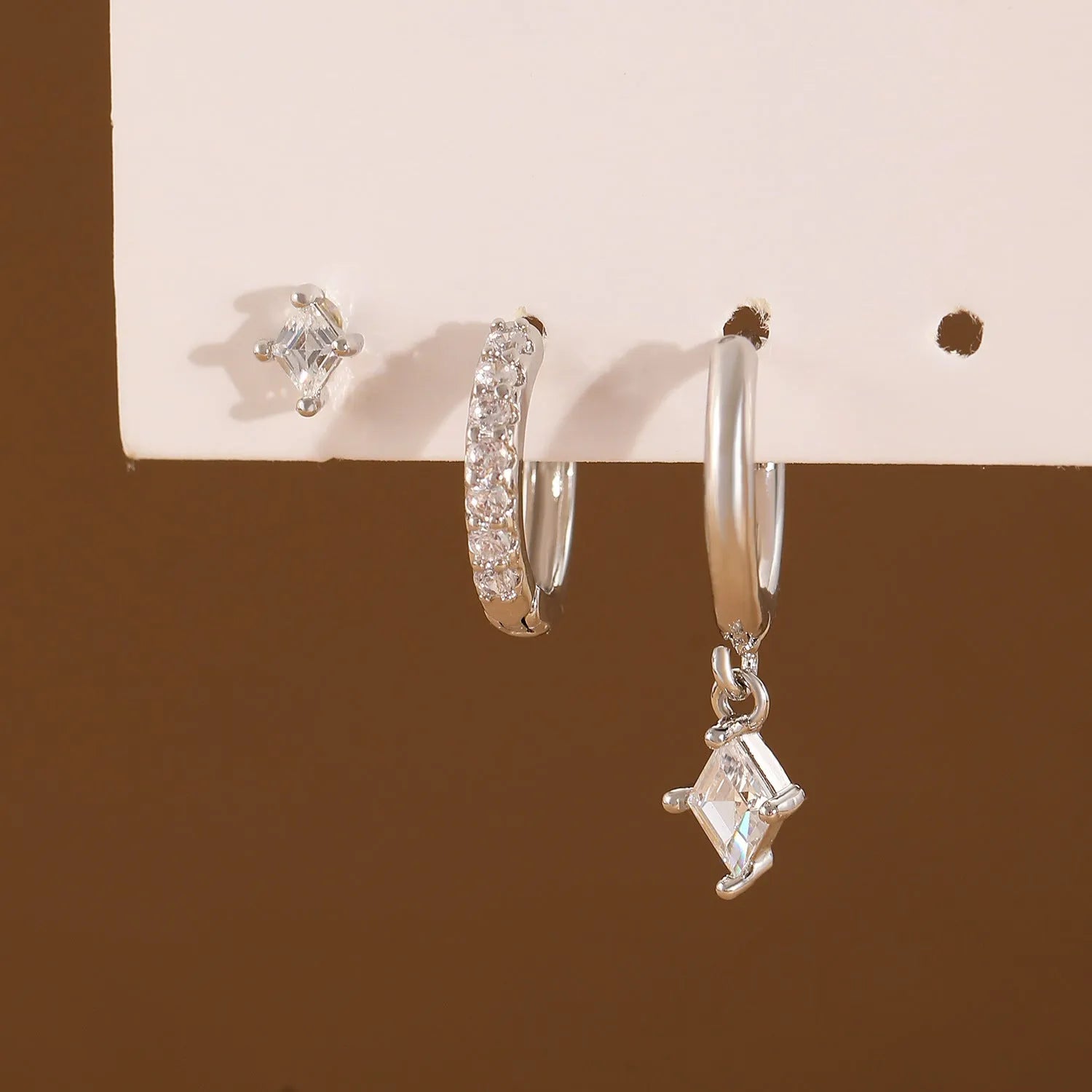 Ladies three-piece zircon inlaid geometric earring set with pendant, stud and clip styles in gold finish