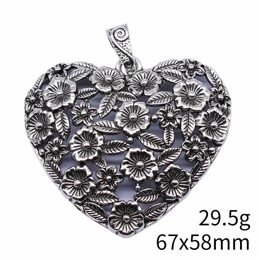 Close-up of a hollow flower love pendant in ancient silver colour, showing its detailed openwork design.