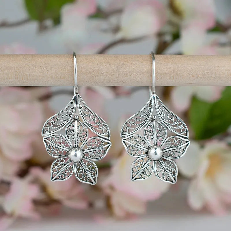 Silver-colour alloy women's earrings with a hollow retro flower leaf shape.