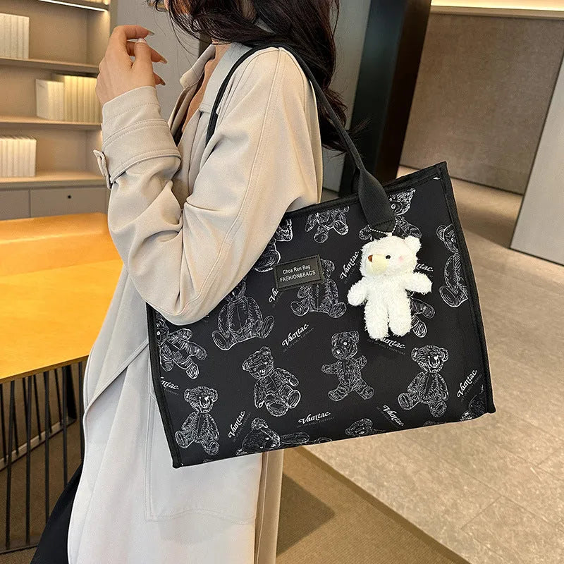 Women's black canvas tote bag with rhombus pattern showing sandwich pocket organisation interior