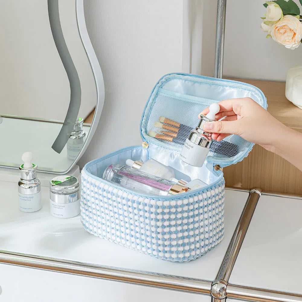 Four cube-shaped polyester makeup bags in matching colour set for travel organisation
