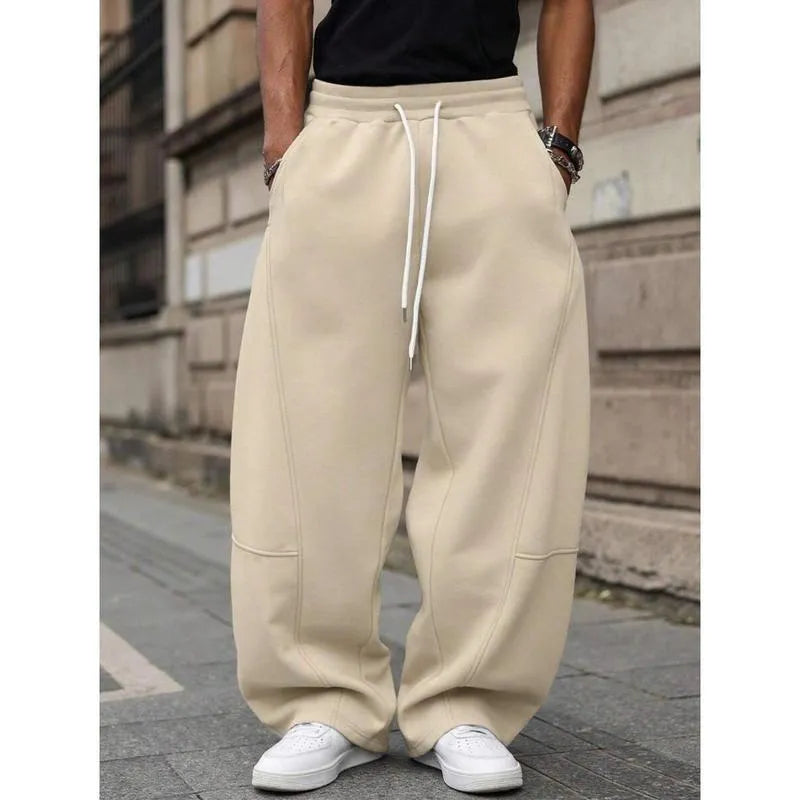 Men's high-waisted straight-leg casual trousers in a neutral colour, showing the cropped length and elasticated fit.