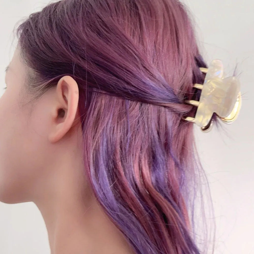 Acetate hair barrettes with metal grip closure in leopard print, beige, white and ink colours
