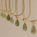 Retro water drop necklace with mixed gem inlaid pendant on a titanium steel snake chain in blue and green colour options.