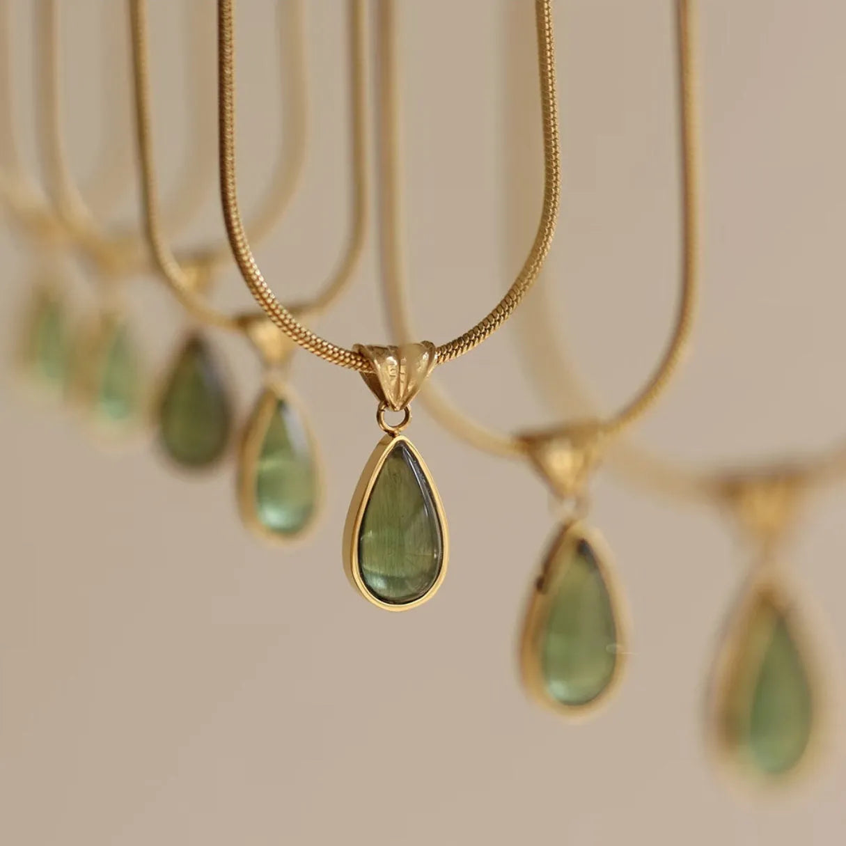 Retro water drop necklace with mixed gem inlaid pendant on a titanium steel snake chain in blue and green colour options.