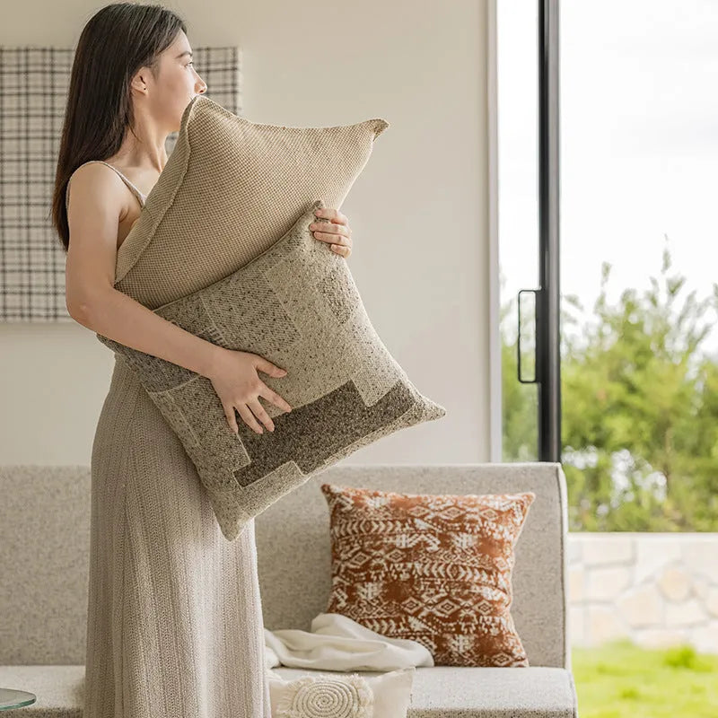 Solid colour rectangular and square sofa cushions with removable covers on a bay window seat