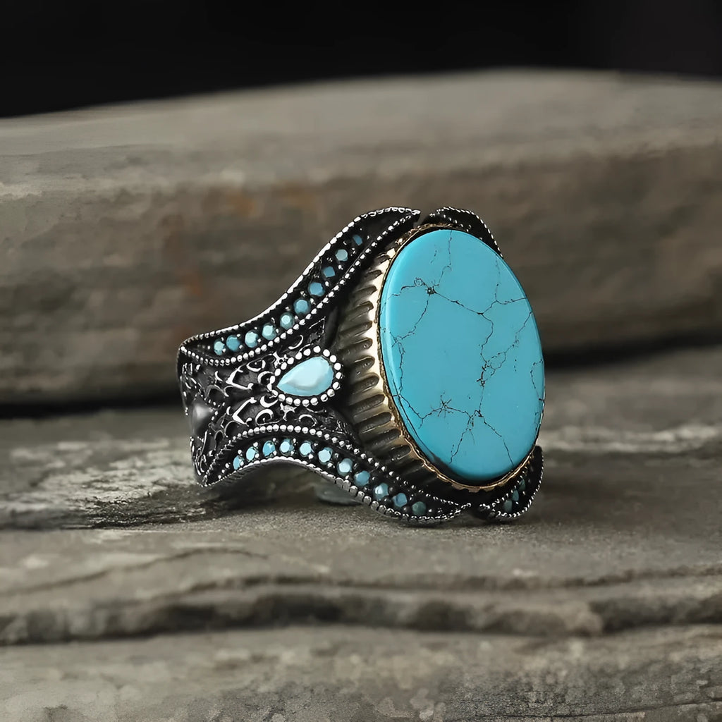 Men's simple round turquoise ring in antique silver colour on a hand.