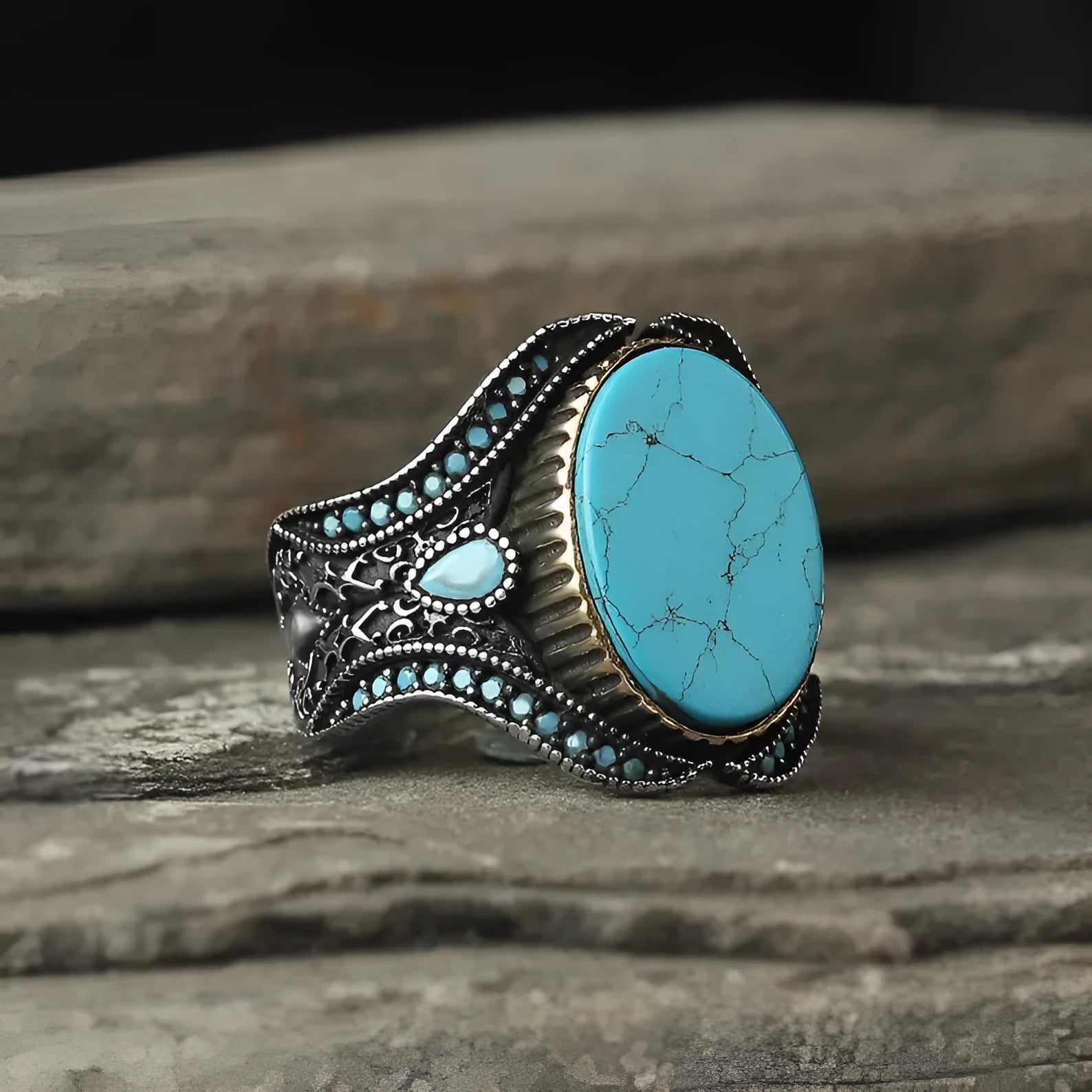 Men's simple round turquoise ring in antique silver colour on a hand.