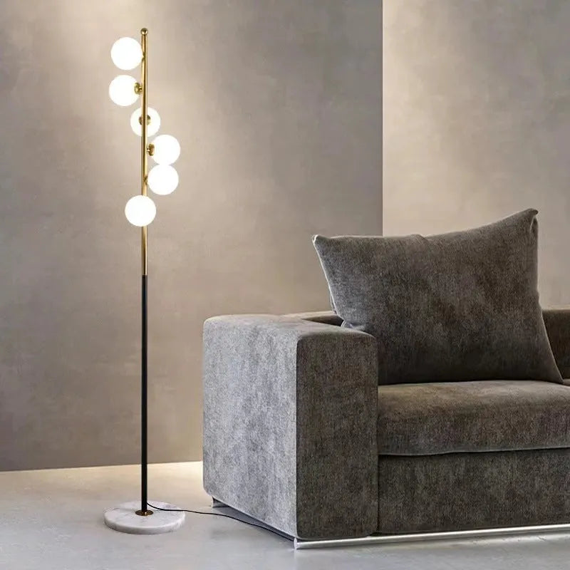 Minimalist modern floor lamp with wrought iron and glass construction, marble base, and adjustable light colours.